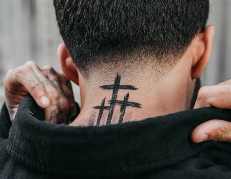 cross on the neck tattoo